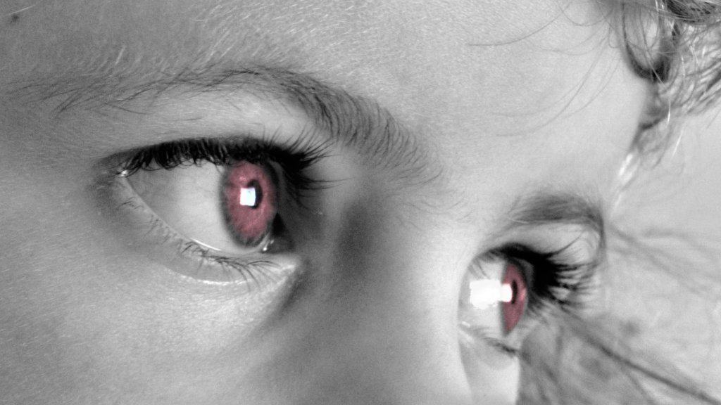 picture of young girls face with red eyes